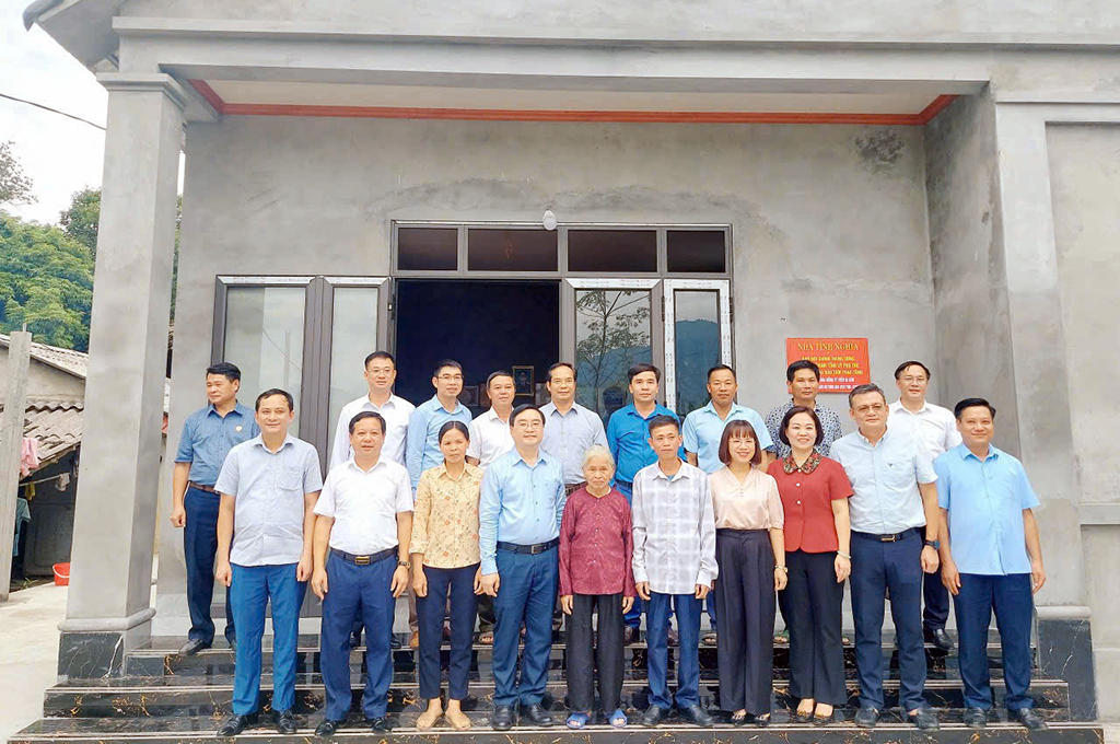 Các đại biểu Ban Nội chính Tỉnh ủy,  Ngân hàng Nhà nước Khu vực 4, lãnh đạo xã Sơn Lương chụp ảnh lưu niệm cùng gia đình anh Nguyễn Huy Bằng